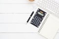 Top view office table desk.Table workspace with office accessories including wireless computer keybook, notebook, pen, calculator Royalty Free Stock Photo