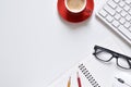 Top view office table, White desk with pencil, book, keyboard, coffee cup, mouse and eyeglasses is elements.