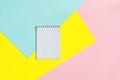 Top view of office tools with blank notebook on blue, yellow and pink background. Space for text Royalty Free Stock Photo