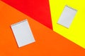 Top view of office tools with blank notebook on orange, yellow and red background. Space for text Royalty Free Stock Photo