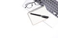 Top view office white table desk. Workspace with computer laptop, keyboard, office supplies, and  eyeglass on white background Royalty Free Stock Photo