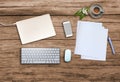 Top view. Office wooden desk with smartphone, hot coffee cup, paper, pencil, notebook, keyboard, mouse and copyspace for text Royalty Free Stock Photo