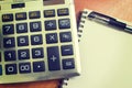 Top view of an office wooden desktop with calculator and pen Royalty Free Stock Photo