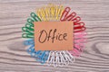 Top view office word and many colored paperclips. Royalty Free Stock Photo