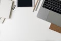 Top view of office workplace. White desk with copy space. Flat lay view on table with laptop, pen, pencil, phone, notebooks Royalty Free Stock Photo