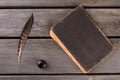 Top view old book with quill and inkpot. Royalty Free Stock Photo