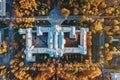 Top view of old building architecture in autumn city landscape with yellow trees and urban traffic Royalty Free Stock Photo