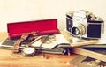 Top view of old camera, antique photographs and old pocket clock Royalty Free Stock Photo