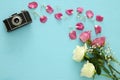 Top view of old camera and roses over wooden table Royalty Free Stock Photo