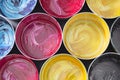 Top view of old CMYK paint cans on dark background. Colorful bac Royalty Free Stock Photo