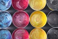 Top view of old CMYK paint cans on dark background. Colorful bac Royalty Free Stock Photo