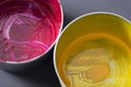 Top view of old CMYK paint cans on dark background. Colorful background. Royalty Free Stock Photo