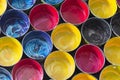 Top view of old CMYK paint cans on dark background. Colorful bac Royalty Free Stock Photo