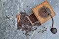 old coffee grinder full of coffee and beans with spices on grey marble bacground Royalty Free Stock Photo