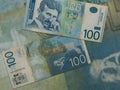 Top view of old damaged blue Serbian 100 dinars banknotes