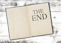 Old open book with text THE END on last page Royalty Free Stock Photo