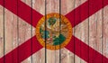 Top view of Old Painted Flag of Florida state, USA on Dark Wooden Fence, wall.US patriot and travel concept. no flagpole. Flag