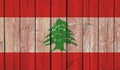 Top view of Old Painted Flag of Lebanon on Dark Wooden Fence, wall. patriot and travel concept. no flagpole. Flag background.