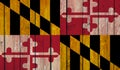 Top view of Old Painted Flag of Maryland state, USA on Dark Wooden Fence, wall.US patriot and travel concept. no flagpole. Flag Royalty Free Stock Photo