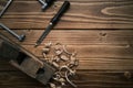 Top view of an old planer and other vintage carpenter tools in a carpentry workshop om a wooden table Royalty Free Stock Photo