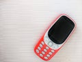 Top view of an old red phone with buttons on a white wooden surface Royalty Free Stock Photo