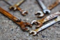 Old rusty wrenches a cement background. Mechanic repair tools