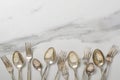 Top view of old stylish spoons and forks on the white mable table.Empty space Royalty Free Stock Photo