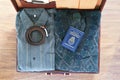 Top view of old suitcase with clothes and passport on wooden flo Royalty Free Stock Photo