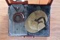 Top view of old suitcase with clothes on wooden floor. Royalty Free Stock Photo