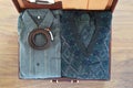 Top view of old suitcase with clothes on wooden floor. Royalty Free Stock Photo