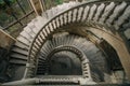 Top view of old vintage decorated spiral staircase in abandoned mansion Royalty Free Stock Photo