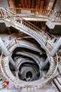 Top view of old vintage decorated spiral staircase in abandoned mansion Royalty Free Stock Photo