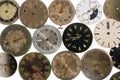 Top view on old worn clock dials on white isolated studio background. Aged scratched round watch faces with hands and