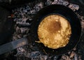 Top view of an omlette in a pan being cooked on coal Royalty Free Stock Photo