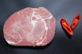 One Piece Raw Pork shoulder with two chili sliced Royalty Free Stock Photo