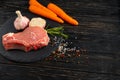 Top view of one pieces raw pork chop steaks with on a black stone cutting board Royalty Free Stock Photo