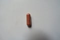 Top view of 1 pink capsule of PQQ dietary supplement Royalty Free Stock Photo