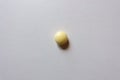 Top view of one round yellow pill of xylitol