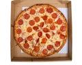 Top view of one whole sliced pepperoni pizza in the box