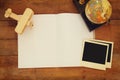 Top view of open blank notebook and and blank polaroid photography frames next to old globes over wooden table. ready for mockup. Royalty Free Stock Photo