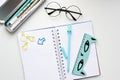 Top view of an open blank notebook with a blue hare-shaped pen, a ruler with a cat, glasses Royalty Free Stock Photo