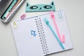 Top view of an open blank notebook with a blue and pink rabbit pen, a ruler, funny clips Royalty Free Stock Photo