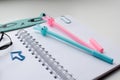 Top view of an open blank notebook with a blue and pink rabbit pen, a ruler and a funny kawaii clips Royalty Free Stock Photo