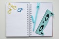 Top view of an open blank notebook with a blue rabbit-shaped pen, a ruler and a funny kawaii clips Royalty Free Stock Photo