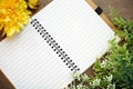 Top view of open blank notebook with flowers on Wood Background. Royalty Free Stock Photo