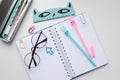 Top view of an open blank notebook with a rabbit pen, a ruler, glasses, funny clips Royalty Free Stock Photo
