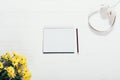 Top view of open blank notepad sheet near yellow flowers Royalty Free Stock Photo