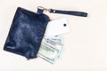 Pouch bag with phone and US dollars on table Royalty Free Stock Photo