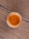 Top view of an open glass jar with Bavarian mustard on a wooden background. Royalty Free Stock Photo