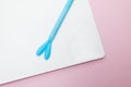 Open notebook page with blue pen on a pale pink background Royalty Free Stock Photo